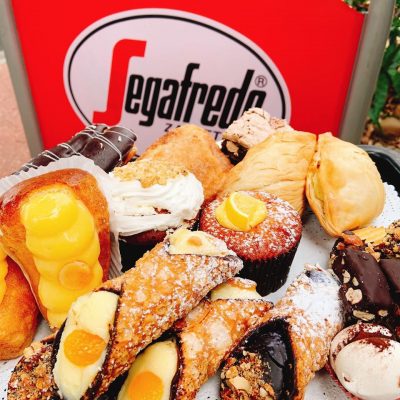 Italian sweets spread out in front of a Segafredo sign